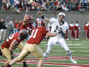 Eli Matt Polhemus ’08 unloads a pass over Cantab defenders as part of Yale’s romp at Harvard Stadium on Nov. 18. The 34-13 win was the Bulldogs’ first since the 2000 Game.
